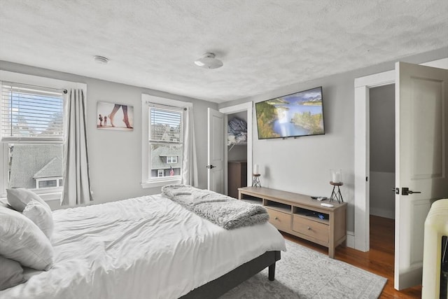 bedroom featuring hardwood / wood-style floors and a textured ceiling