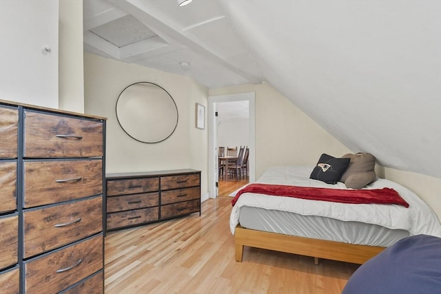 bedroom with light hardwood / wood-style floors and lofted ceiling