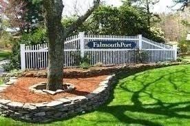 225 SW Mdws Unit 225, Falmouth, MA 02536 - view of gate featuring a lawn and fence