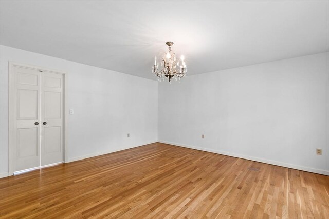9 William Bradford Rd, Dartmouth, MA 02747 - empty room featuring a chandelier, light wood finished floors, and baseboards