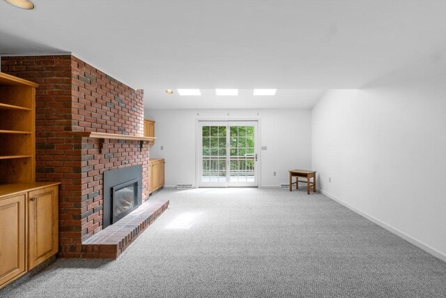 9 William Bradford Rd, Dartmouth, MA 02747 - unfurnished living room featuring a fireplace, light colored carpet, and baseboards