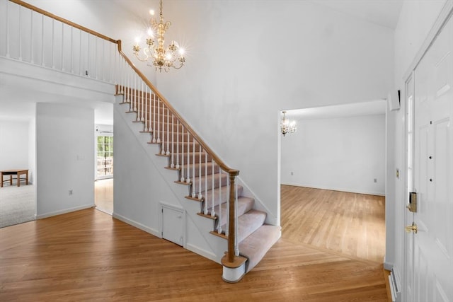 9 William Bradford Rd, Dartmouth, MA 02747 - stairs with a chandelier, a high ceiling, wood finished floors, and baseboards
