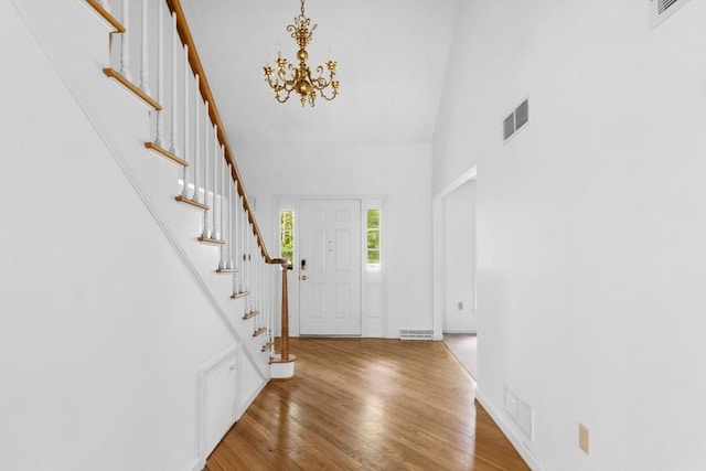 9 William Bradford Rd, Dartmouth, MA 02747 - foyer featuring a chandelier, stairs, wood finished floors, and a high ceiling