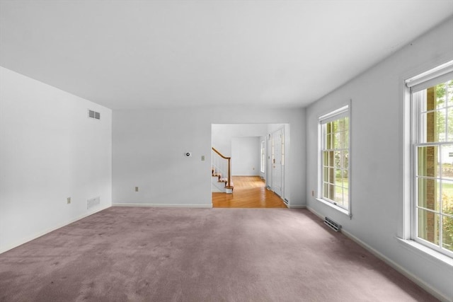 9 William Bradford Rd, Dartmouth, MA 02747 - unfurnished living room with carpet, stairway, and baseboards