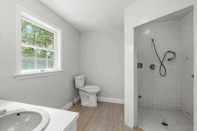 9 William Bradford Rd, Dartmouth, MA 02747 - full bath featuring vanity, tiled shower, wood finished floors, baseboards, and toilet