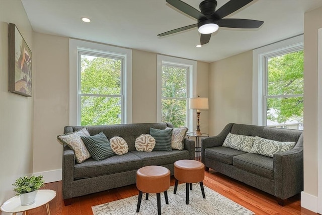 living area with wood finished floors, ceiling fan, recessed lighting, and baseboards