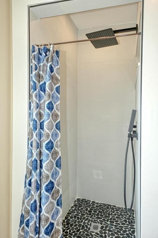 full bathroom with tiled shower