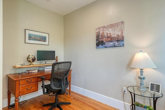 office space with baseboards and wood finished floors