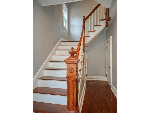 stairway featuring wood finished floors