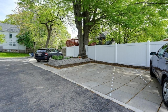 view of car parking featuring fence