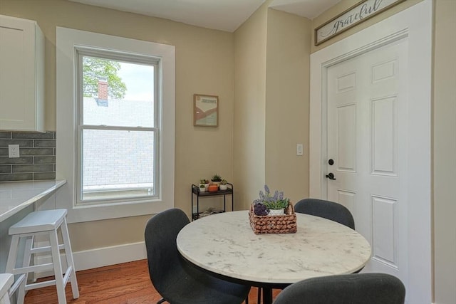 dining area featuring wood finished floors and baseboards