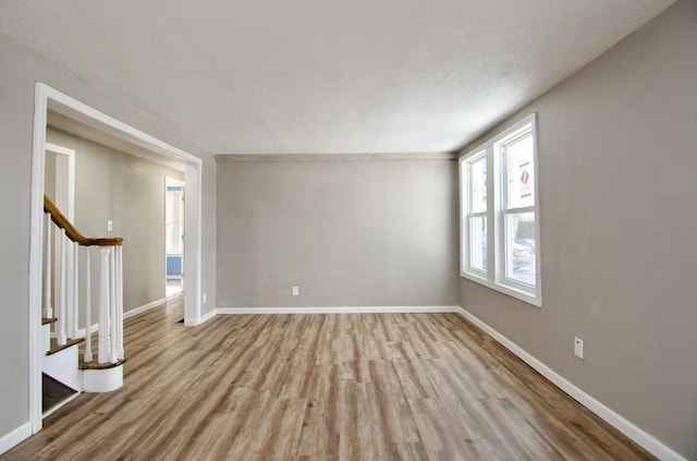 spare room featuring light wood-type flooring