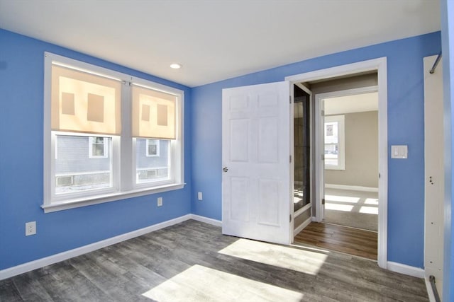 unfurnished bedroom with dark hardwood / wood-style flooring