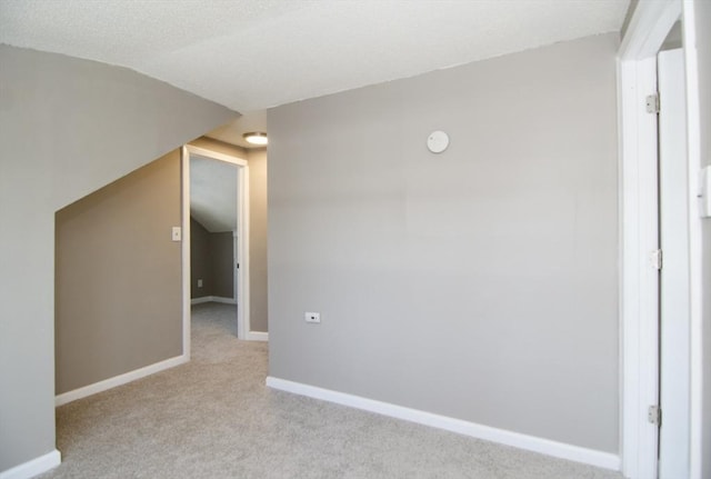 additional living space with light carpet and lofted ceiling