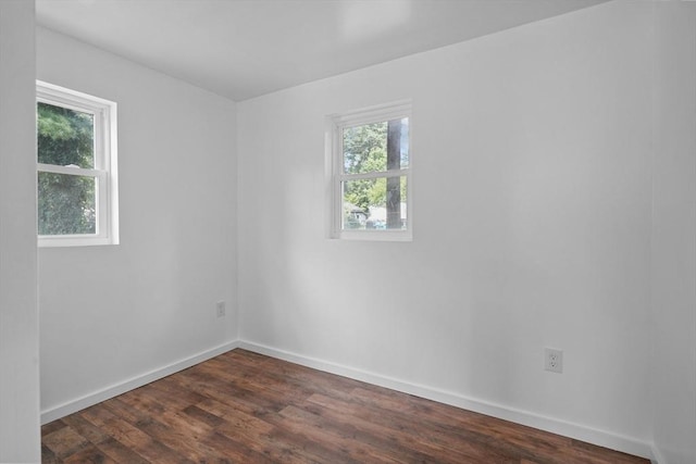 spare room featuring dark wood-type flooring