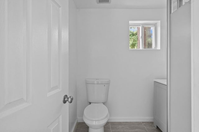 bathroom featuring tile patterned floors, vanity, and toilet