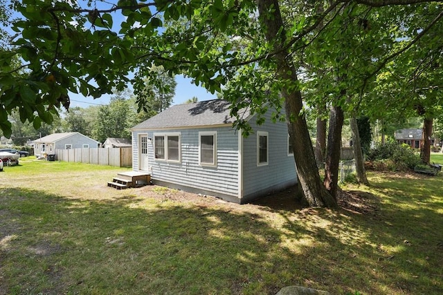 view of side of property with a yard