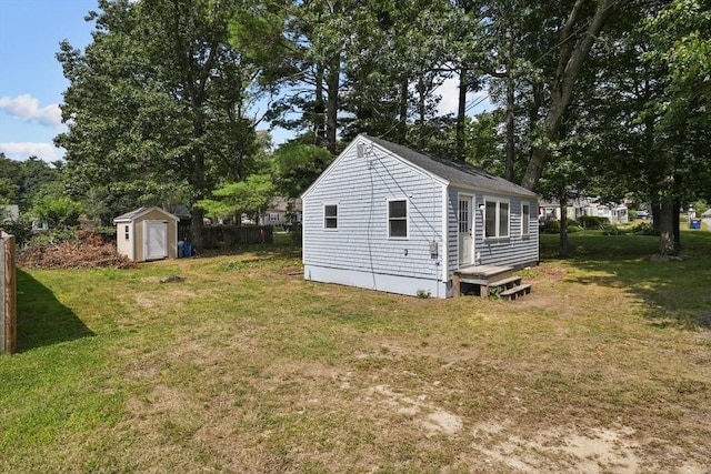 exterior space featuring a yard and a storage unit