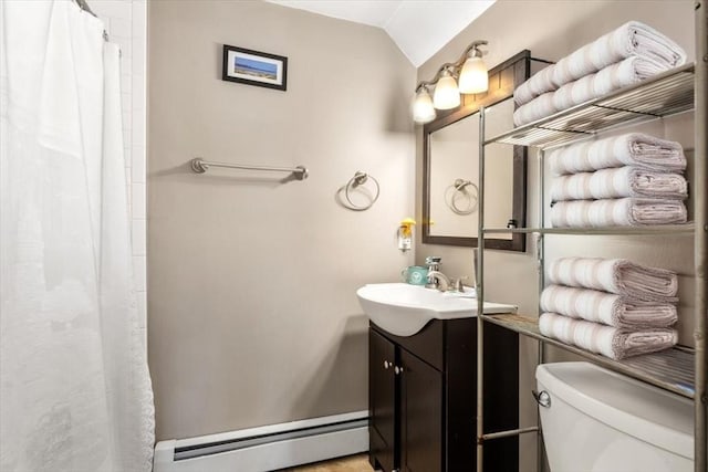 bathroom featuring vaulted ceiling, toilet, vanity, a shower with curtain, and a baseboard radiator