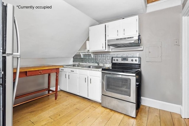 kitchen featuring backsplash, freestanding refrigerator, stainless steel range with electric cooktop, under cabinet range hood, and light wood-style floors