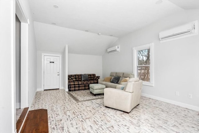 living room featuring baseboards, vaulted ceiling, and a wall mounted AC