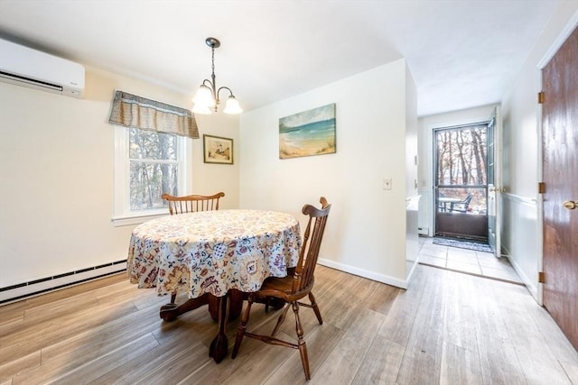 dining area with a chandelier, a baseboard heating unit, a wall mounted air conditioner, and light hardwood / wood-style floors