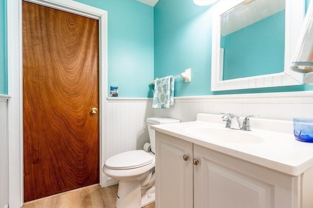 bathroom with vanity, wood-type flooring, and toilet