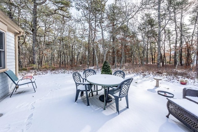 snow covered patio with a fire pit