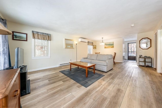 living room with a baseboard radiator, light hardwood / wood-style flooring, and an AC wall unit