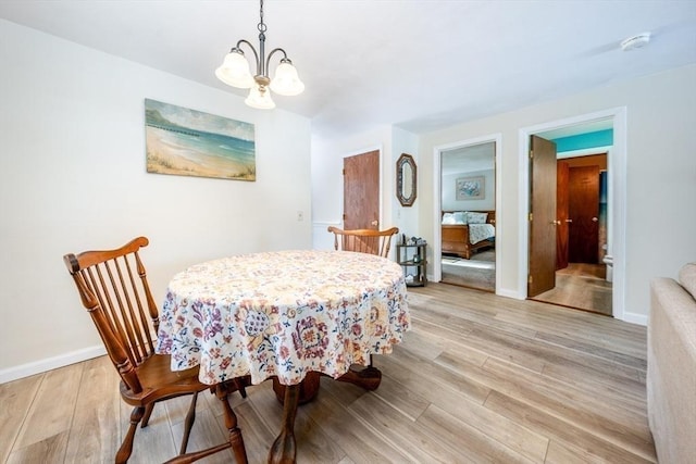 dining room with a notable chandelier and light hardwood / wood-style floors