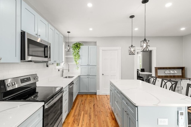 23 Schoolhouse Rd, Templeton, MA 01468 - kitchen with appliances with stainless steel finishes, a sink, recessed lighting, a kitchen island, and light wood-type flooring