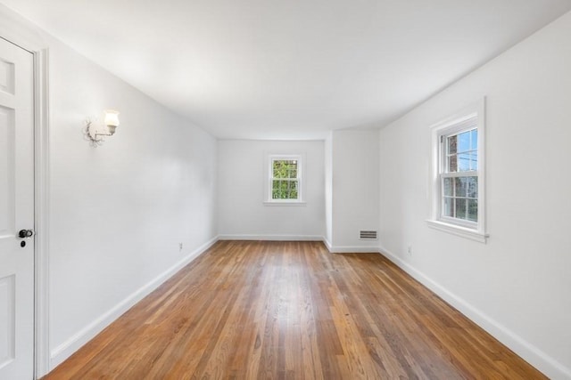 unfurnished room featuring light wood-style flooring and baseboards