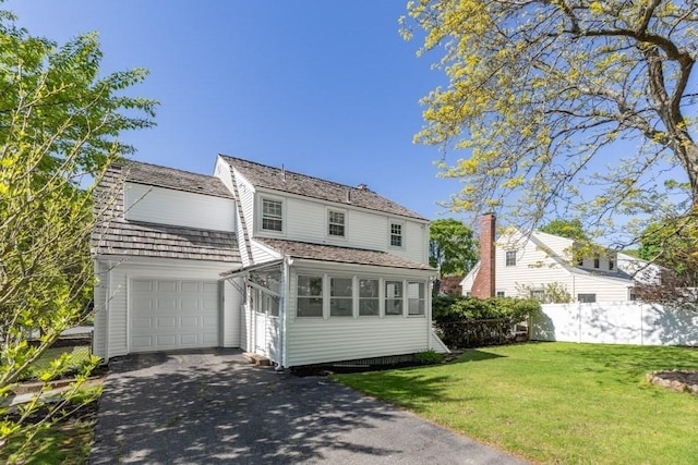 traditional-style home with driveway and an attached garage