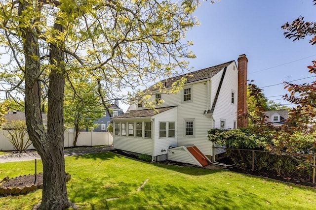 rear view of house featuring a chimney