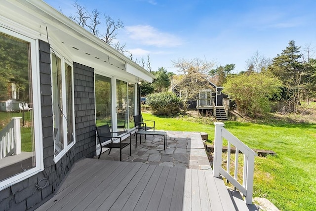 wooden terrace featuring stairs, a yard, and a patio area