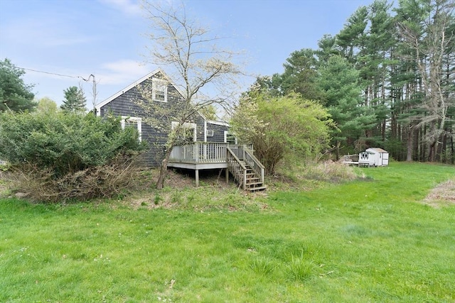 exterior space with an outdoor structure, a storage shed, and a deck