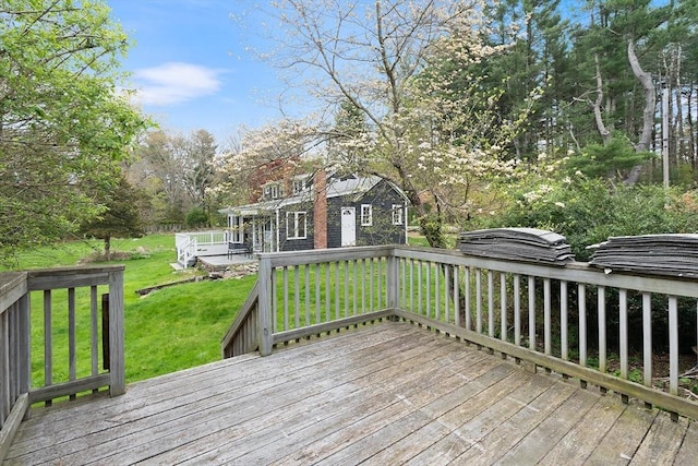 wooden terrace featuring a yard