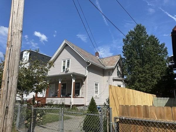 44 James St, Holyoke, MA 01040 - view of front of house featuring covered porch, a fenced front yard, and a gate