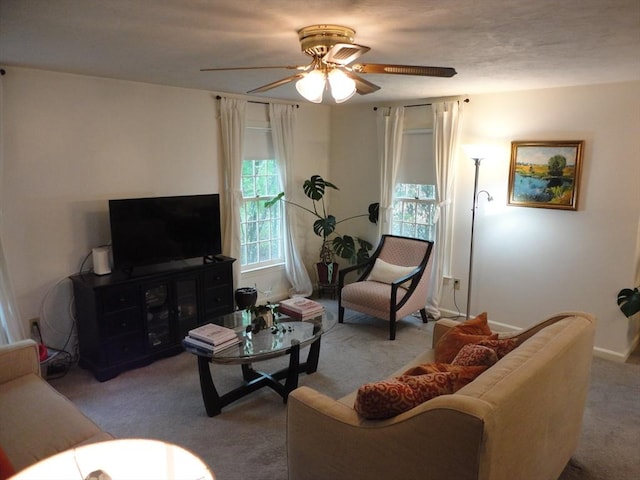 carpeted living room featuring ceiling fan