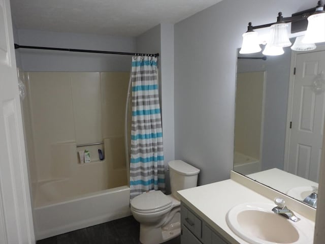 full bathroom with shower / bath combination with curtain, vanity, and toilet