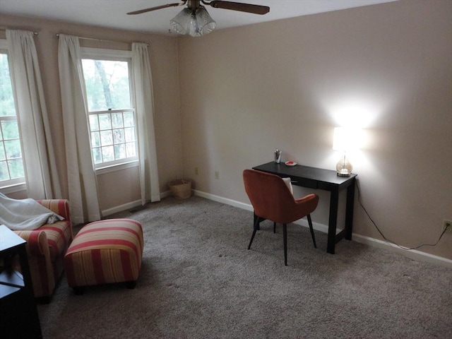 carpeted home office featuring ceiling fan and baseboards