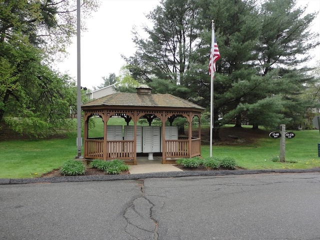 view of community with mail area, a lawn, and a gazebo