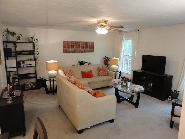 living room featuring light carpet and ceiling fan
