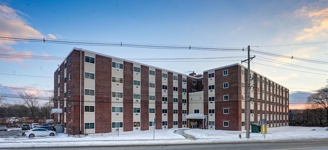 snow covered building featuring cooling unit