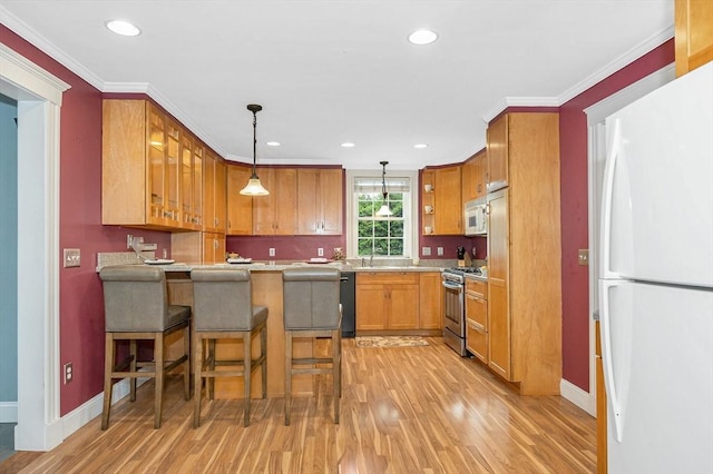 35 Warren Ave, Reading, MA 01867 - kitchen featuring white appliances, light wood finished floors, baseboards, a peninsula, and a kitchen bar