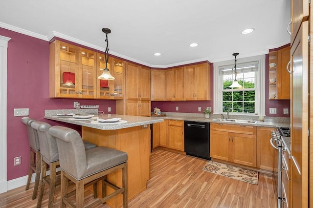 35 Warren Ave, Reading, MA 01867 - kitchen with dishwasher, a sink, light wood-style flooring, a kitchen bar, and stainless steel gas range oven