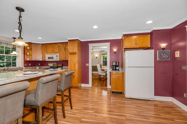 35 Warren Ave, Reading, MA 01867 - kitchen featuring white appliances, light wood-style flooring, baseboards, healthy amount of natural light, and crown molding