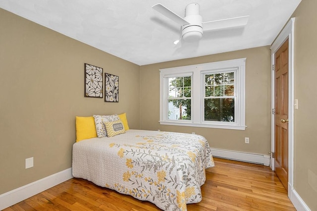 35 Warren Ave, Reading, MA 01867 - bedroom featuring baseboard heating, light wood-type flooring, baseboards, and a ceiling fan