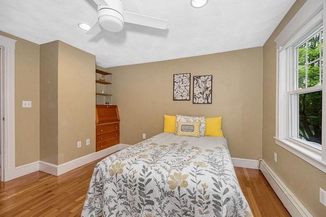35 Warren Ave, Reading, MA 01867 - bedroom featuring a baseboard heating unit, light wood finished floors, baseboards, and ceiling fan