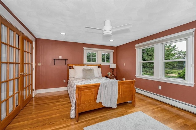 35 Warren Ave, Reading, MA 01867 - bedroom featuring baseboard heating, light wood-style flooring, baseboards, recessed lighting, and a ceiling fan